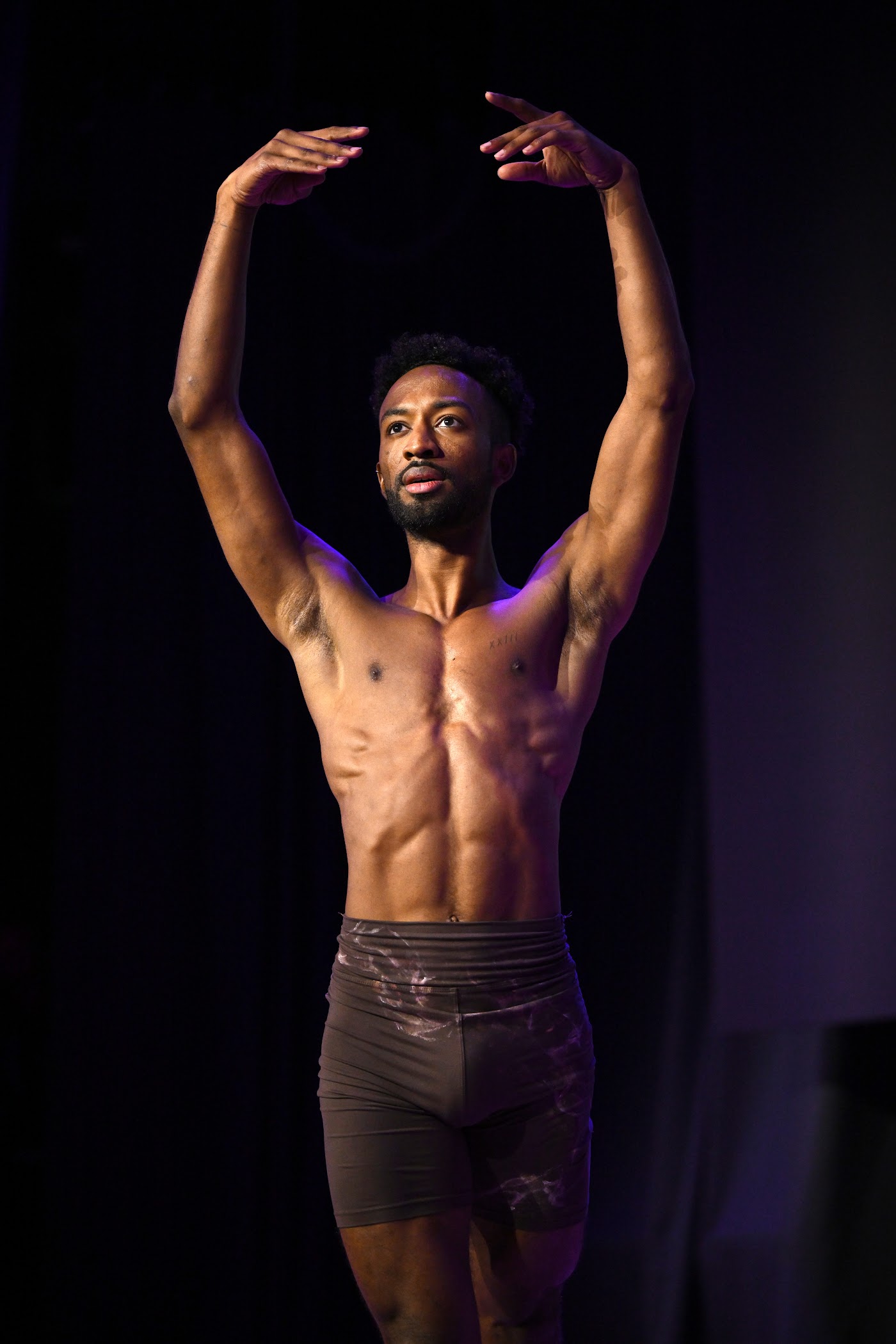 A dancer holds a ballet pose on stage at Future Forum