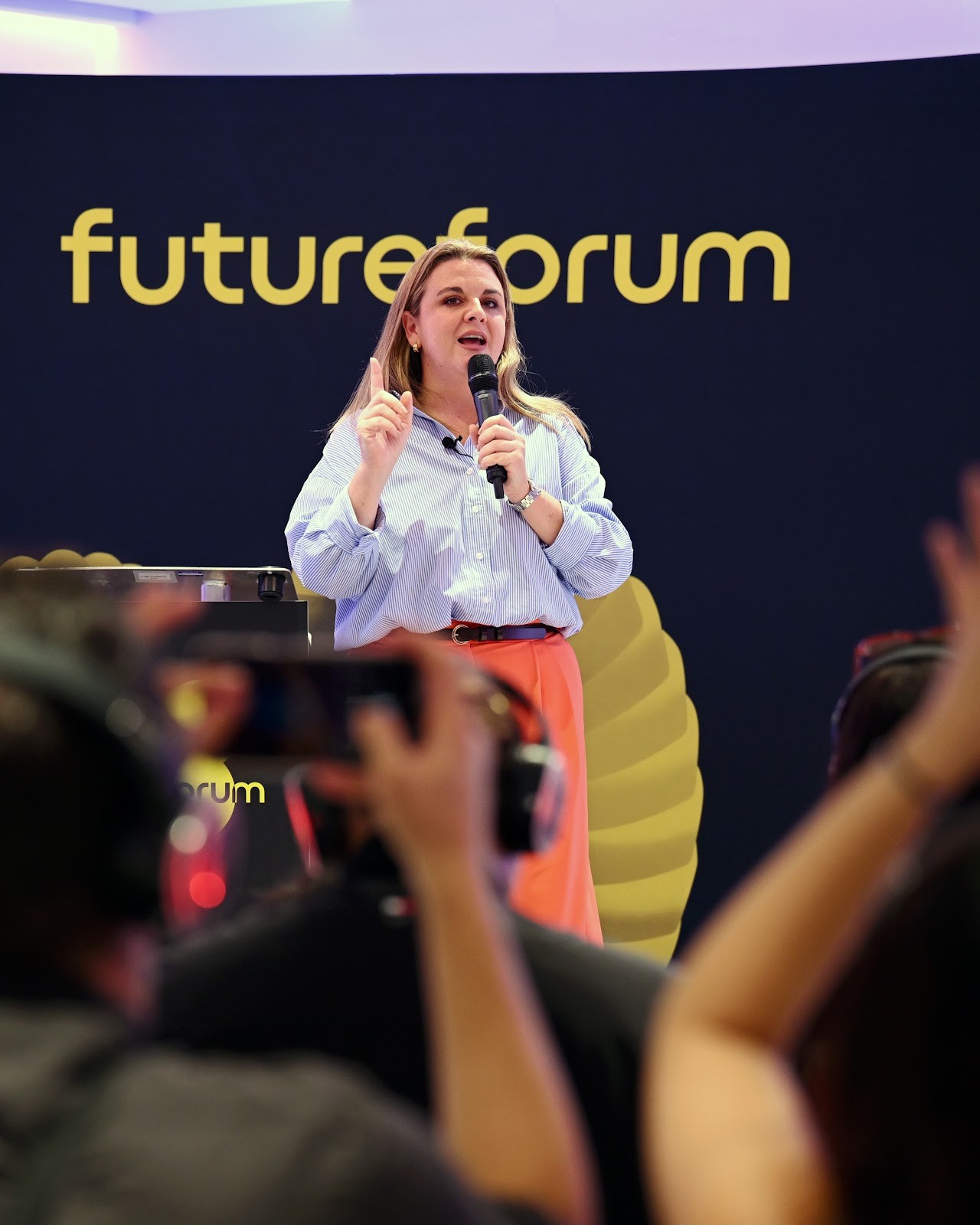 Delegates raise their phones to film a speaker at Future Forum