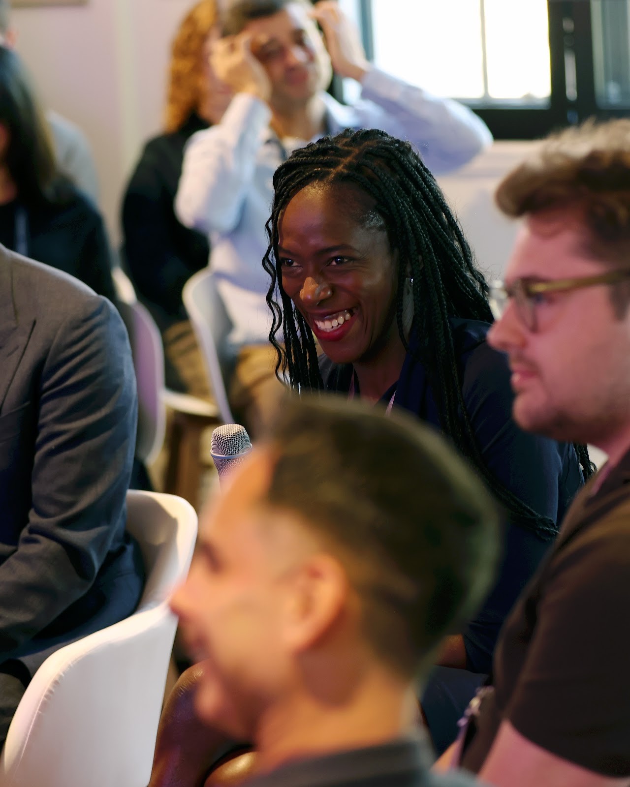 Delegates share a laugh during a session in the Salon at Town Hall