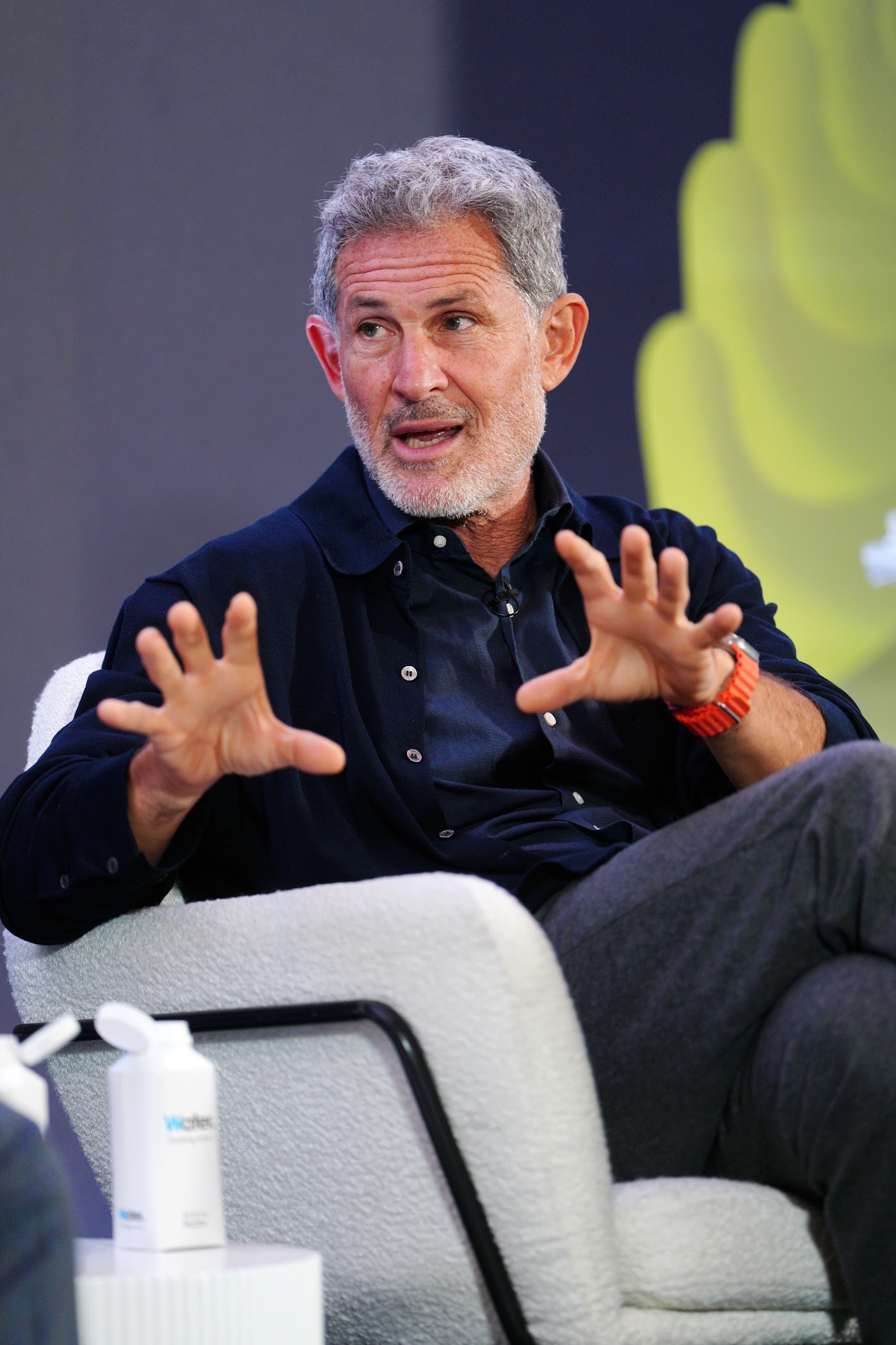 A speaker gestures mid-conversation on stage at Future Forum