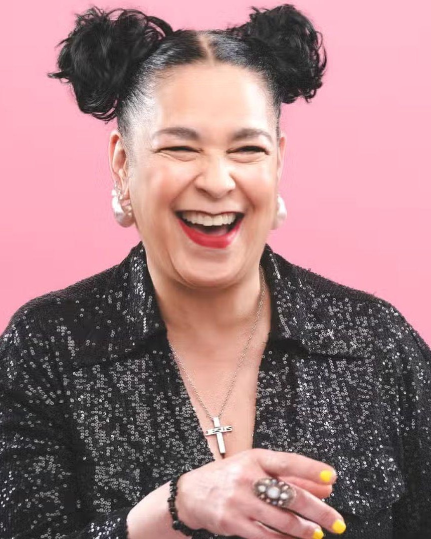 Josephine Lacey laughing against a pink background