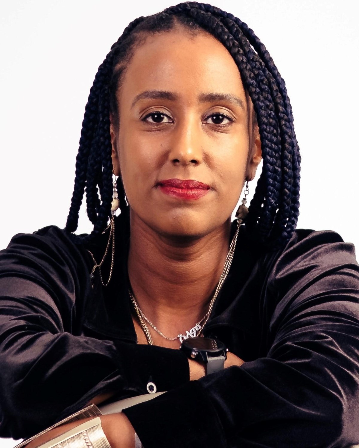 Selam Amare with her arms folded, looking into the camera