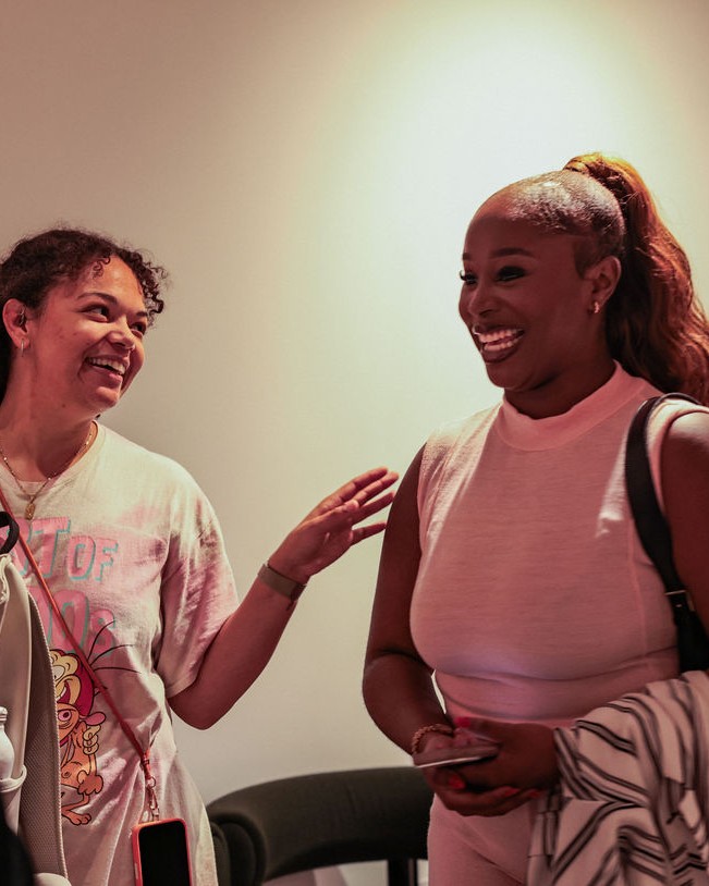 Two guests share a laugh during the evening