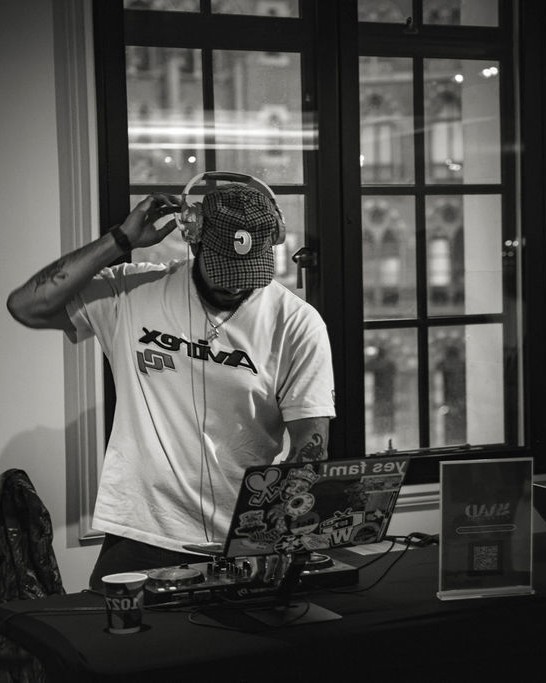 A DJ plays music during the evening