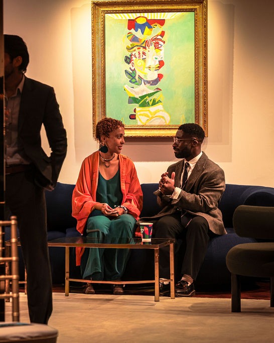 Two guests deep in conversation on a sofa in the Salon